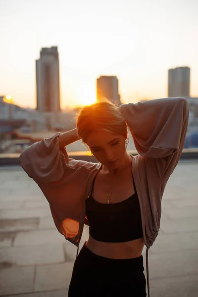 depositphotos_578962600-stock-photo-young-woman-posing-roof-amazing